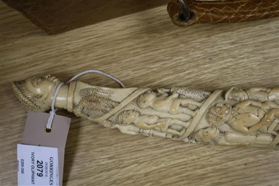 A Belgian Congo ivory oliphant, c.1900, carved with a procession of figures, hammerhead shark fishermen and 41cm